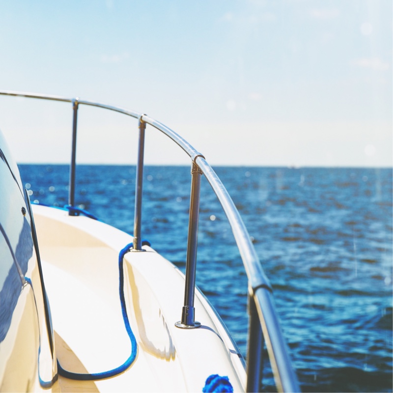 Overlooking the ocean waters from the railing of a boat.